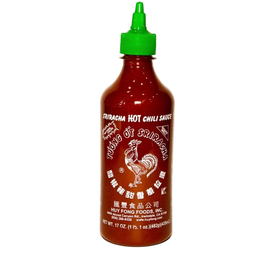 Bottle of Sriracha hot chili sauce with a green cap on a white background