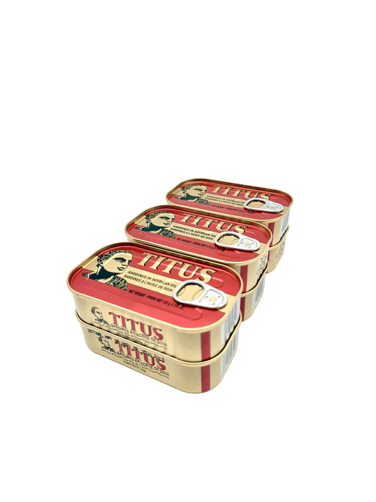 Three tins of Titus products stacked on a white background